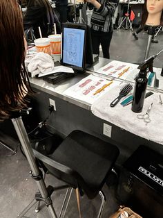 two mannequins are sitting at a table with hair products on it