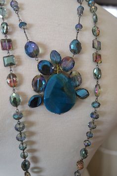 "Wedding necklaces, evening jewelry in crystal & glass. 3 colors to choose from, blue crystal, & purple crystal & Greeen glass combination. measures about 21 inches -one way. these are stunning in person. If you want several necklaces I will adjust the \"per piece\" price https://www.facebook.com/pg/RetroVintageWeddings1920s1930s/photos/?tab=album&album_id=2712728162156543" Iridescent Jeweled Jewelry For Parties, Elegant Iridescent Crystal Jewelry, Unique Jewelry With Faceted Beads For Party, Costume Jewelry With Faceted Beads For Evening, Evening Costume Jewelry With Faceted Beads, Faceted Crystal Jewelry For Parties, Elegant Blue Crystal Necklaces For Parties, Elegant Handmade Iridescent Crystal Necklace, Party Crystal Jewelry With Faceted Details