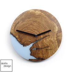 a wooden clock with an image of a tree trunk on it's face and hands