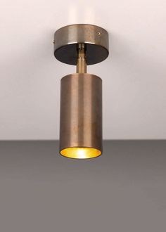 a close up of a light fixture on a white wall with a gray floor in the background