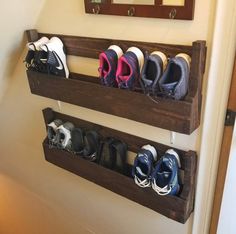 there are several pairs of shoes on the shelf above the door and in front of the mirror