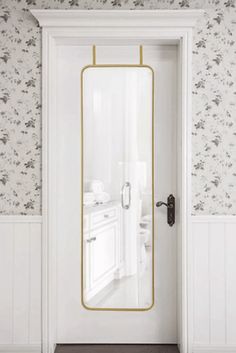 an open door in a bathroom with wallpaper