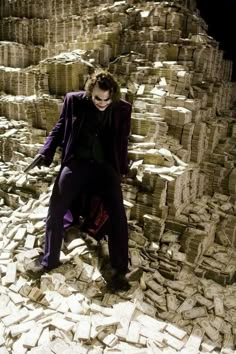 the joker standing in front of stacks of bricks