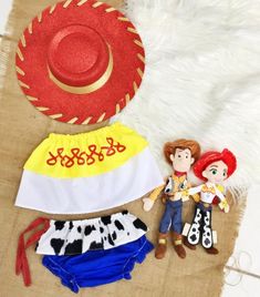 two dolls are laying next to each other on a white furnishing area with cowboy hats