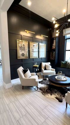 a living room with black walls and white furniture