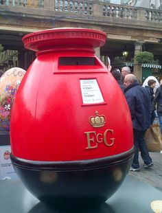 a large red egg shaped object on display