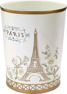 the eiffel tower is decorated with flowers and gold trimmings on this trash can