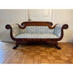 a wooden bench sitting on top of a hard wood floor