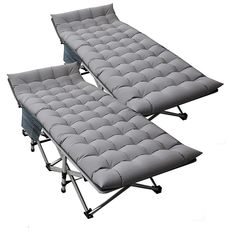 two fold out beds sitting next to each other on top of metal frame legs with wheels