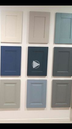 a wall with many different colored doors on it