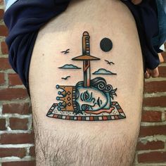 a man with a tattoo on his thigh