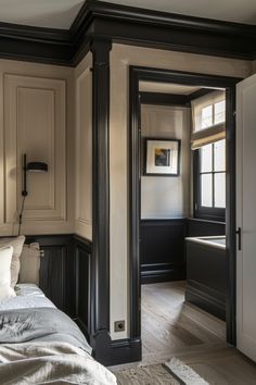 a bedroom with white walls and black trim