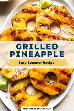 grilled pineapple on a white plate with lime wedges