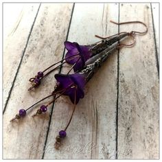 Her tiny face smeared with blackberry juice, the Blackberry Fairy laughs, having a grand old time . . . These gorgeous earrings are made from hand dyed, two toned lucite flowers in deep purple and a deeper rose shade, accented in antique copper components, and feature crystal glass beads.  These earrings measure approximately 4" long from ear wire to base, and are super light. All of my items are handmade by myself here in Denver, Colorado, and I personally dye 90% of the flowers as well. Perfect for gift giving, special occasions, and everyday wear, these have a whimsical flair.  All of my jewelry will be packaged on a custom designed display card and packed securely. Questions?  Contact me at shesabelledesigns@gmail.com. Be sure to "Like" my Facebook page at www.facebook.com/shesabellede Handmade Purple Flower Earrings Whimsical Style, Purple Handmade Whimsical Flower Earrings, Handmade Purple Whimsical Flower Earrings, Unique Purple Flower Earrings, Whimsical Purple Dangle Flower Earrings, Blackberry Flower, Blackberry Juice, Lucite Flower Earrings, Display Cards