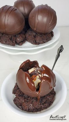 two white plates topped with chocolate covered cookies and marshmallows on top of each other