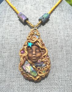 This little dreamer holds a lot of sparkle in her locks. Tiny crystals are all through this piece. The necklace is woven to 17" and held by clasp.  3 Druzy Agate points are centered in the pendant itself and two barrel druzy beads and woven into the necklace. Unique and one of a kind gift. Comes gift wrapped  and boxed for safe shipping.  Druzy stones are wonderful to help us amplify our self healing abilities. These beautiful stones bring heightened intuition and balance to our spiritual selves. We can all use a little more unconditional love for ourselves and others in a world gone bi polar ️.. this pendant has a peaceful and tranquil feeling about it. This talisman was charged with the full spectrum solfeggio frequencies from bottom to top. Much love to who ever this piece will go to 🤗 Handmade Goddess Pendant Necklace, Mystical Handmade Adjustable Beaded Necklace, Magical Adjustable Pendant Necklace, Handmade Adjustable Mystical Beaded Necklace, Handmade Adjustable Mystical Beaded Necklaces, Handmade Adjustable Mystical Crystal Necklace, Mystical Handmade Adjustable Crystal Necklaces, Mystical Handmade Adjustable Crystal Necklace, Handmade Mystical Necklaces