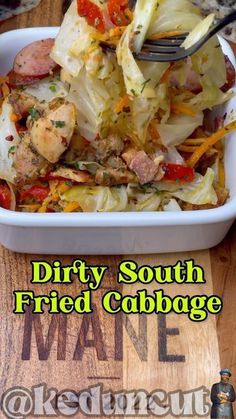 dirty south fried cabbage with meat and vegetables in a white dish on a wooden cutting board