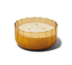 a candle that is inside of a glass bowl on a white surface with some candles in it