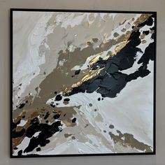 an abstract painting with gold, black and white colors on it's surface is shown