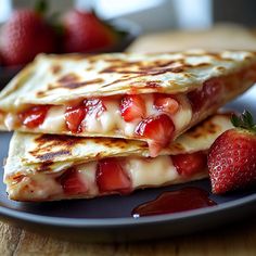 two quesadillas on a plate with strawberries