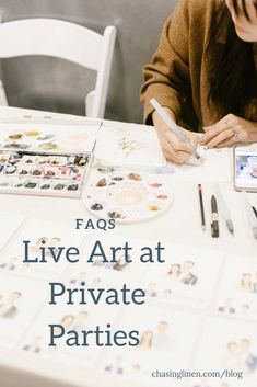 a woman is sitting at a table with her phone and some pictures on the table