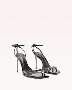 The Skye sandal translates timeless allure. The delicate square toe lends an air of sophistication to the design while the upper showcases lines of crystals, creating a mesmerizing interplay of light and sparkle. The back of the sandal features delicate and slender straps that elegantly frames the feet. Material: Vernice Buff Leather sole Square toe Heel height: 3.9in | 100mm SKU: B0605000040003 Square Toe Heels, Alexandre Birman, Heel Height, Sparkle, Sandals, Square, Crystals, Heels, Leather