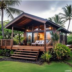 a small wooden house sitting on top of a lush green field next to palm trees