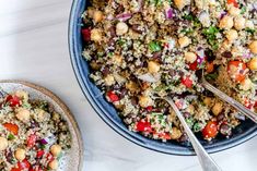 two bowls filled with food on top of a white counter next to silver spoons