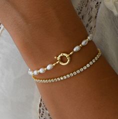 Simple and elegant pearl bracelet! Pairs nicely with other bracelets, but is also beautiful on it's own. Includes .5" extender. Materials: 14K Gold Plated / Pearls Elegant Silver Pearl Bracelet, Pearl Wedding Bracelet With 17 Jewels, Classic Pearl Charm Bangle Jewelry, Classic Pearl Charm Bangle, Elegant Bangle Charm Bracelet For Anniversary, Gold Plated Classic Pearl Bracelet, Classic Gold-plated Pearl Chain Bracelet, Elegant Adjustable Bracelet With Pearl Drop, Classic Pearl Charm Bangle Bracelet