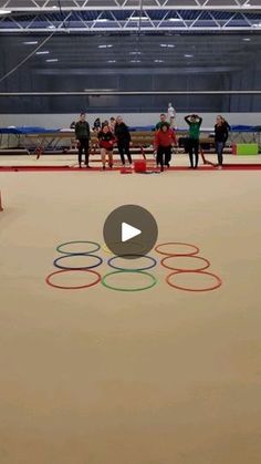 a group of people standing around an olympic ring