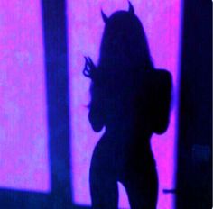 the silhouette of a woman is shown in front of a pink and blue background,