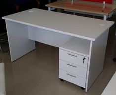 an office desk with three drawers on each side and two chairs in the back ground