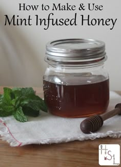 a mason jar filled with honey sitting on top of a table next to a wooden spoon