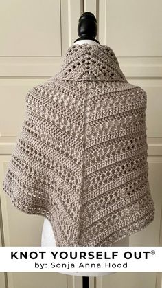 a crocheted shawl with the words knot yourself out written in white on it