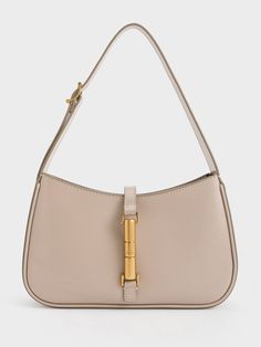 This product is made with at least 20% sustainable materials by weight. CHARLES & KEITH uses recycled, degradable, organic, and water-based materials in our eco-conscious collection.Taupe is the neutral colour to be seen in this season. An elegant blend of brown and grey, this understated hue will bring a refreshing touch to your new seasonal everyday wardrobe. Consider incorporating it in the form of the Cesia, featuring a clean-lined silhouette that will effortlessly elevate any look with eleg Eco-friendly Neutral Rectangular Shoulder Bag, Everyday Beige Shoulder Bag With Bamboo Handle, Everyday Cream Shoulder Bag With Bamboo Handle, Cream Shoulder Bag With Bamboo Handle For Everyday Use, Eco-friendly Shoulder Bag With Bamboo Handle, Natural Baguette Shoulder Bag For Everyday, Modern Rectangular Neutral Shoulder Bag, Modern Neutral Rectangular Shoulder Bag, Beige Recyclable Tote Shoulder Bag