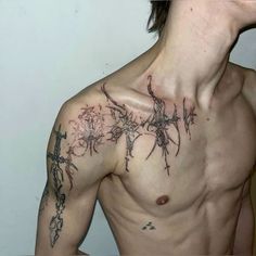 a shirtless man with barbed wire on his chest