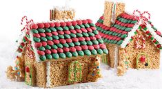 three gingerbread houses are decorated with candy canes and candies in the snow