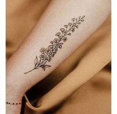 a woman's arm with a flower tattoo on the left side of her body