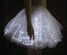 a woman wearing a white skirt with lights on it