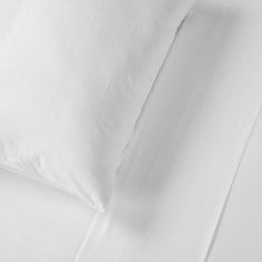 white sheets and pillows on top of each other