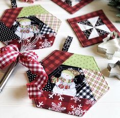 the quilts are laying on the table next to the christmas tree and other decorations