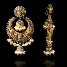 A fun pair with classic deign that never goes out-of-style! Gorgeous pair of earrings that is a perfect pick to pull-off any traditional or ethnic look. With its beautiful metal carving, embossed details and timeless jhumki design with an addition to pearl moti, this pair is all you need for the upcoming events. Kajal Earrings are available in two sizes. Big earrings are about 4.5" long and small earrings are about 3" long. Gold-plated on high-quality brass as base metal. Delivery time frame is Traditional Oxidized Hoop Earrings For Festive Occasions, Gold Oxidized Finish Jhumkas Gift, Gold Oxidized Finish Jhumkas For Festivals, Gold Oxidized Jhumkas Gift, Oxidized Gold Jhumkas For Gift, Festive Gold Oxidized Jhumkas, Traditional Gold Metal Chandbalis, Festive Brass Jhumkas, Ornate Chandelier Earrings With Intricate Design For Ceremonial Occasions