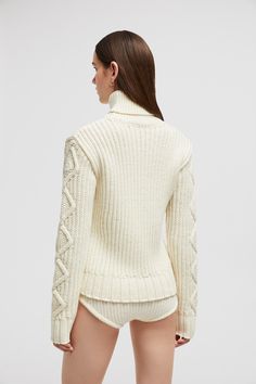 A combination of intricate knitting techniques enrich this wool sweater with a sophisticated texture. Featured in a feminine color palette, the design elevates cold weather looks with its elegant finish. Elegant Textured Knit Sweater For Winter, Elegant Cable Knit Winter Sweater, Elegant Textured Knit Sweater, Luxury White Wool Sweater, Elegant Knitted Turtleneck Sweater, Elegant Cable Knit Turtleneck Sweater, Elegant Cashmere Knit Sweater, Elegant Textured Knit Sweater In Winter White, Fitted Luxury Merino Wool Sweater