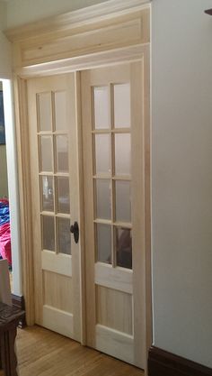 the inside of a house with wooden floors and double doors