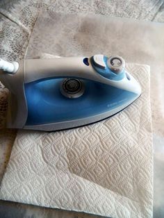 a blue and white iron sitting on top of a towel