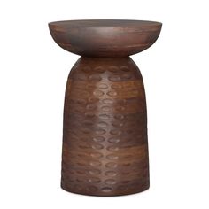 a brown vase with holes on the side and a wooden base that is made out of wood