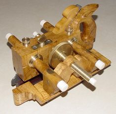 a small wooden machine that is made out of wood and has white knobs on it