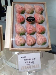 there are many strawberries in the box on display