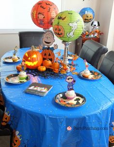 a blue table topped with lots of halloween decorations