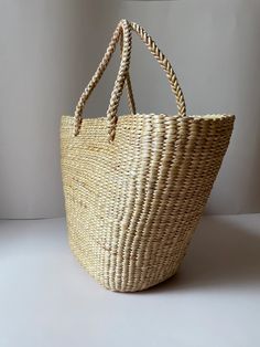 This tote bag is made from handwoven water hyacinth, making it eco-friendly and sturdy. It comes in two variations: with and without inner linings. This product can carry all your necessities, making it a great fashionable and functional accessory for casual days. Phayao Puktobchawa is a socially conscious Thai brand that supports the members of the Phayao province, providing an avenue for creative expression and income. Their products are handwoven from water hyacinth using local techniques and span a range of forms such as bags, baskets, picture frames, hats, shoes, and souvenirs. Natural Beach Bag With Rolled Handles For Daily Use, Natural Bucket Straw Bag With Large Capacity, Natural Color Large Capacity Bucket Straw Bag, Natural Large Capacity Bucket Straw Bag, Large Capacity Natural Straw Bucket Bag, Natural Color Rectangular Crochet Bag With Rolled Handles, Rectangular Natural Crochet Bag With Rolled Handles, Natural Rectangular Crochet Bag With Rolled Handles, Eco-friendly Rectangular Straw Bag With Rolled Handles